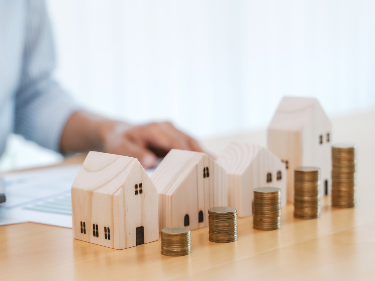 Immobilienbewertung in Berlin mit Hausmodellen und Münzen